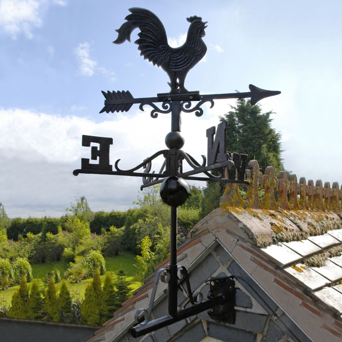 Cat iron Rooster Weathervane mounted on house