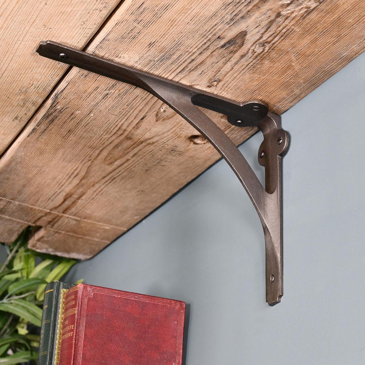 Looking up at the Cast Iron Stylish Architectural Shelf Bracket Holding up a Shelf Looking up at the Cast Iron Stylish Architectural Shelf Bracket Holding up a Shelf