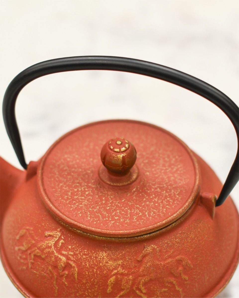 Close up of Black Iron Handle on Cast iron Teapot 