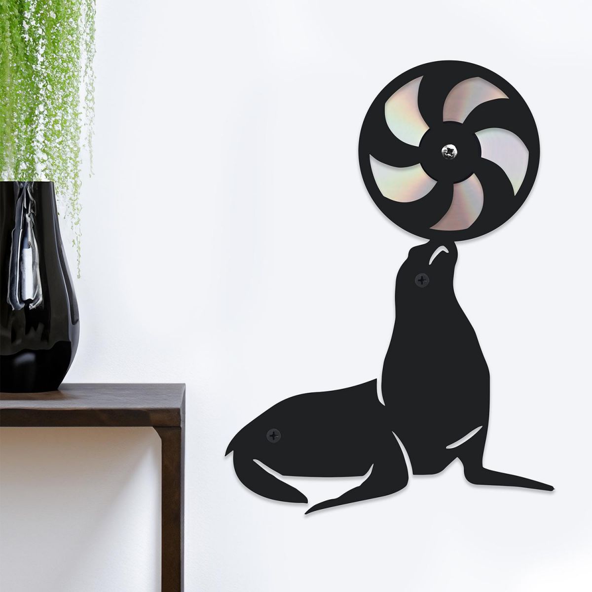 CD Seal With Ball On White Background Next To Plant