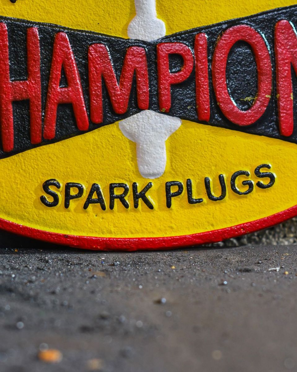 Close up of "Champion" Cast Iron Automobilia Reproduction Sign finish Close up of "Champion" Cast Iron Automobilia Reproduction Sign finish