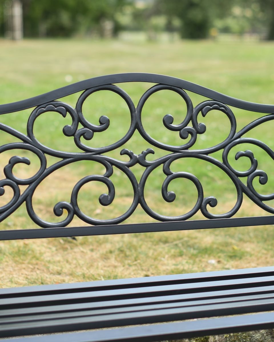 Close up of ornate scrollwork detail on classic black garden bench Close up of ornate scrollwork detail on classic black garden bench