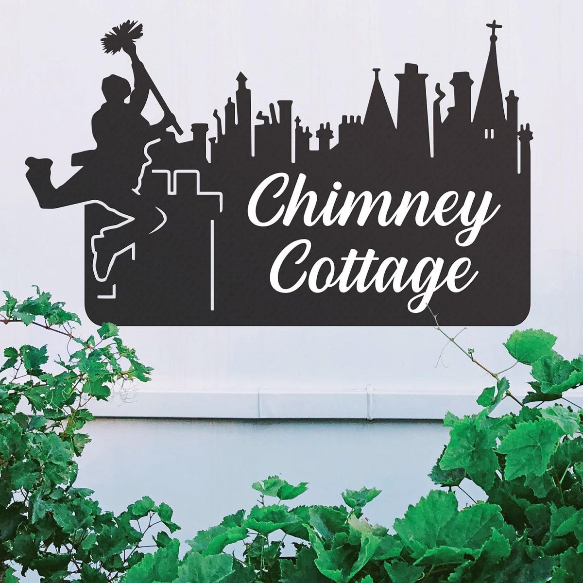 Black Chimney Sweep Iron House Name Sign on a White Wall