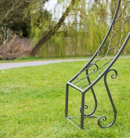 Close-up of the Scrolled Detailing on the Bottom of the Circular Grey Rose Arch Close-up of the Scrolled Detailing on the Bottom of the Circular Grey Rose Arch