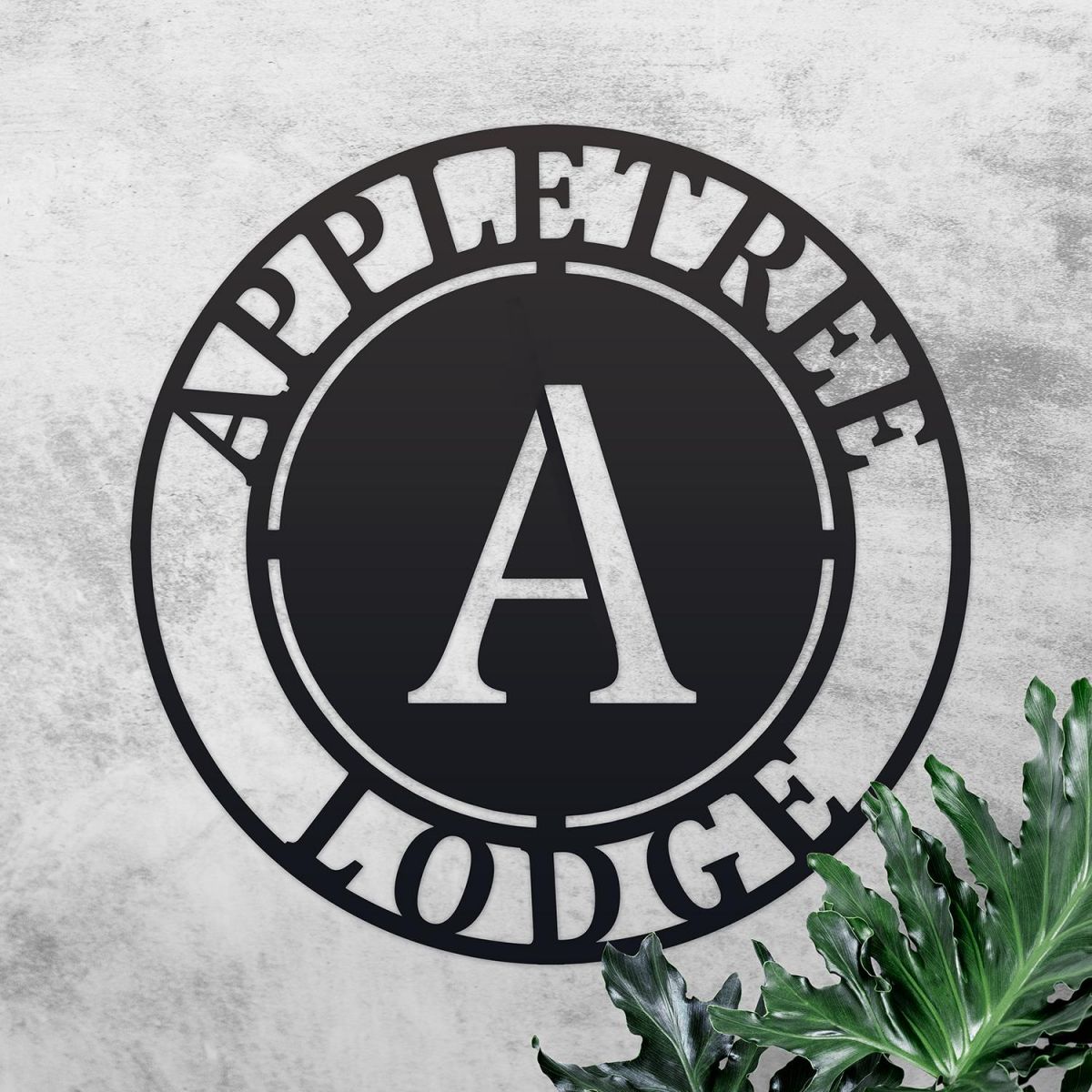 Circular Iron House Name Sign on a Rustic Wall