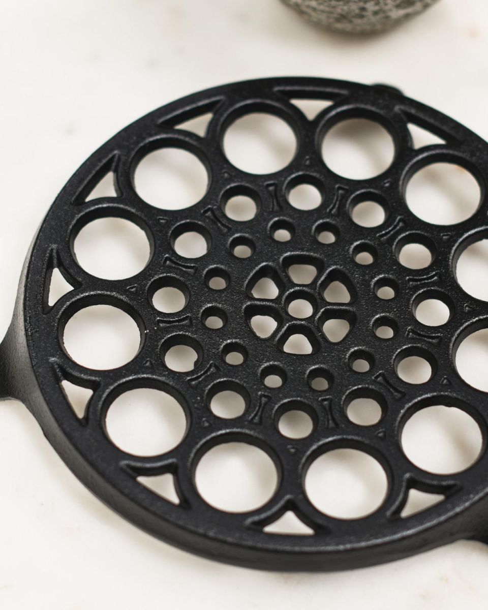 Close-Up of Circular "Spotted" Cast Iron Trivet in Black Close-Up of Circular "Spotted" Cast Iron Trivet in Black