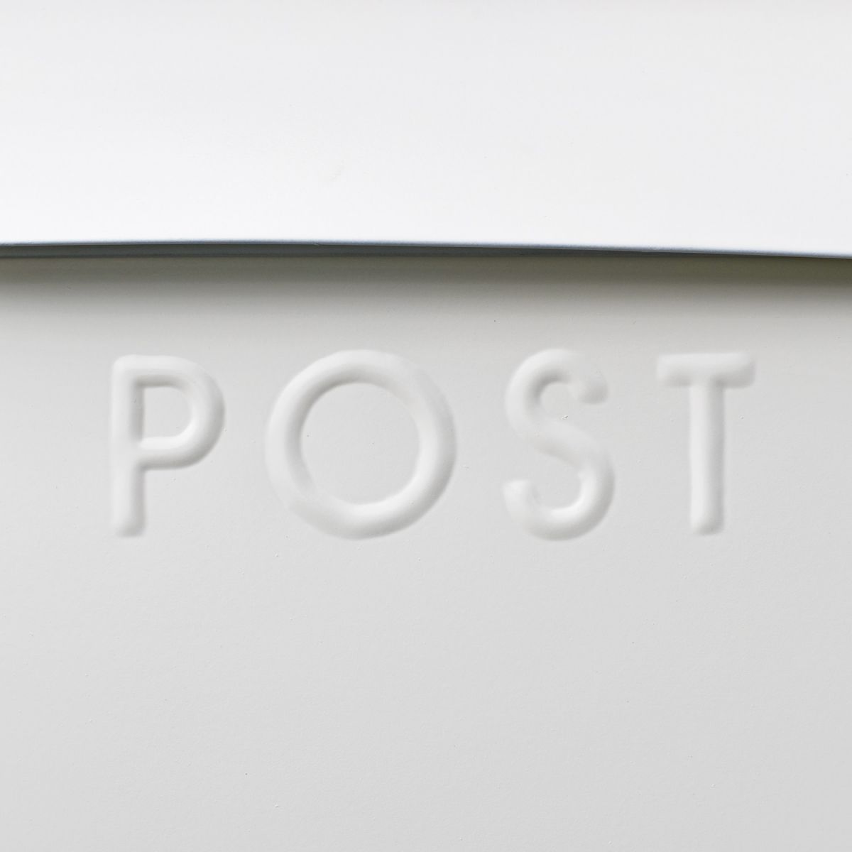 Close-up of the Embossed Lettering on the White Post Box