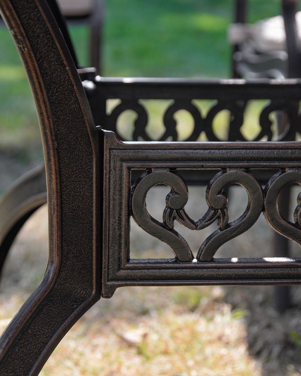 The "Highgrove" 8-Seater Luxury Garden Dining Set - Antique Copper Table Lower Table Heart Details Close Up 