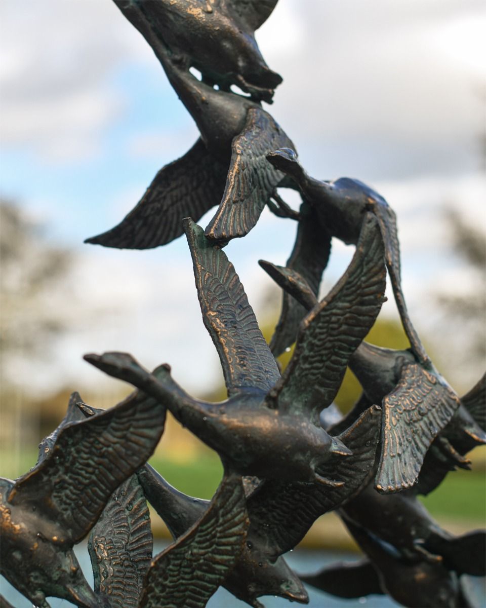 Close up of Flock of Flying Ducks Garden Sculpture 