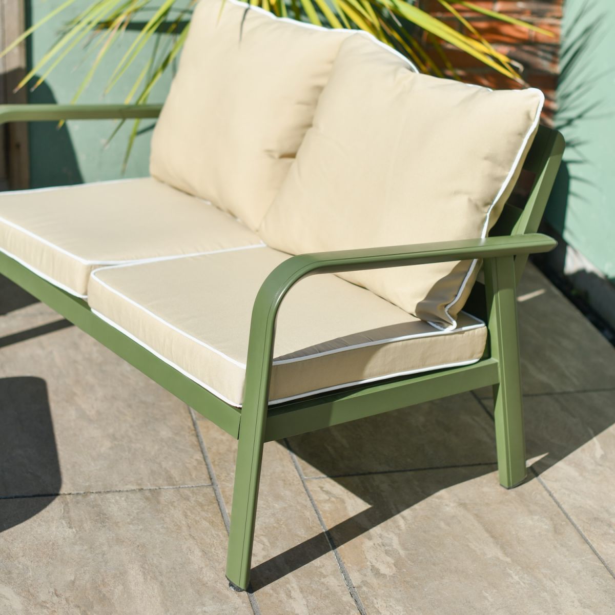 Close up of green metal arm detail on two seater outdoor sofa