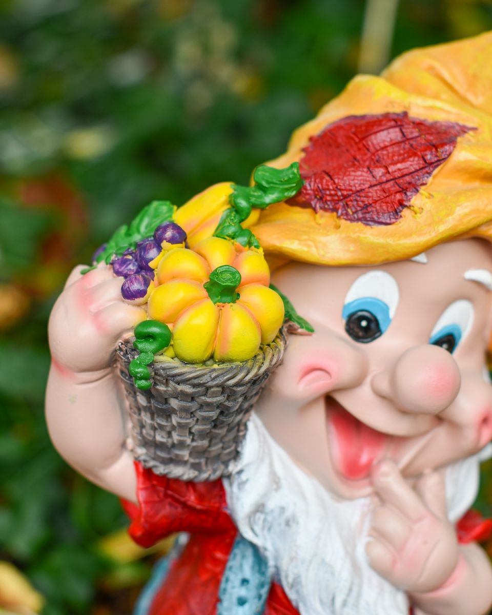 Close up of intricate basket of vegetable detail on colourful garden gnome ornament