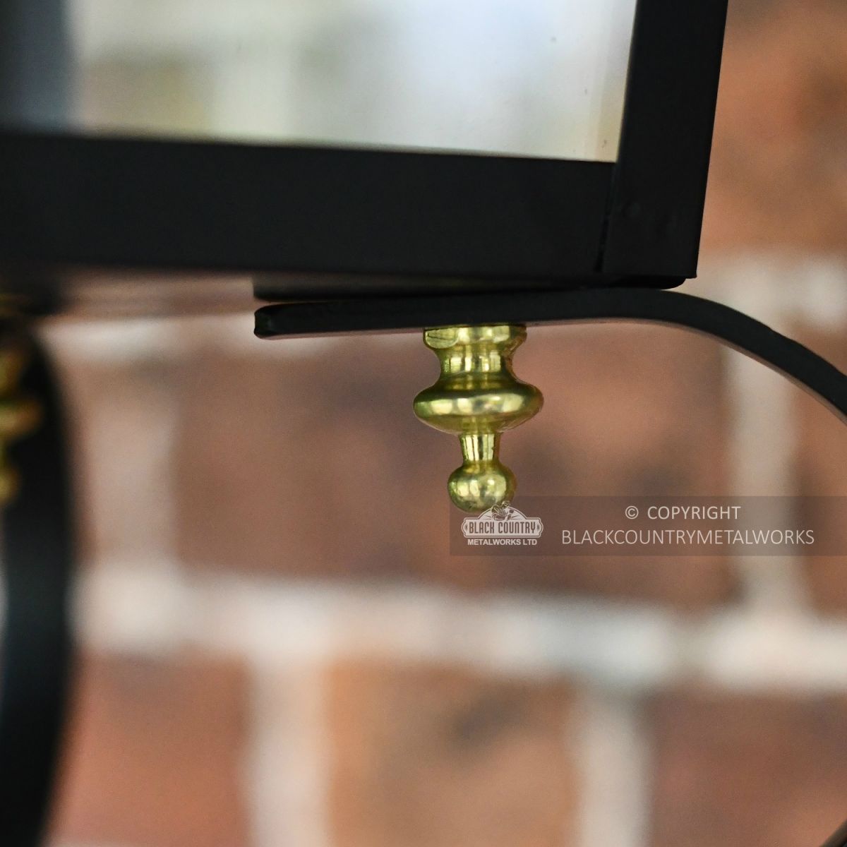 Close Up Of Black Lantern and Brass Decorative Finial