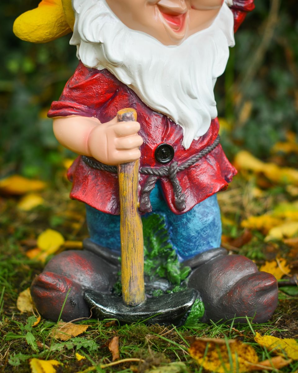 Close up of intricate clothes detail on colourful garden gnome ornament Close up of intricate clothes detail on colourful garden gnome ornament