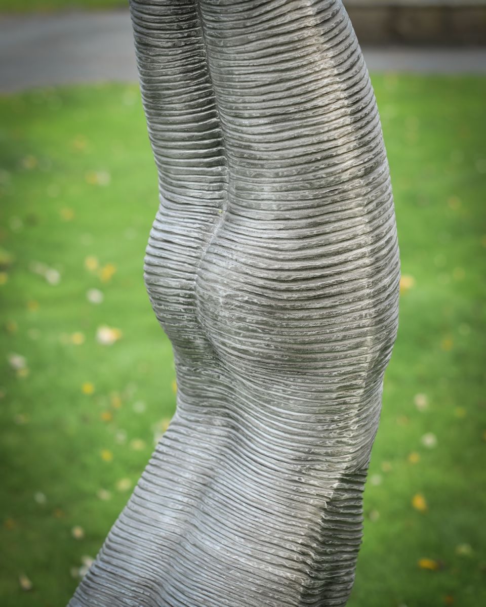 Close up of body detail on layered aluminium outdoor art sculpture