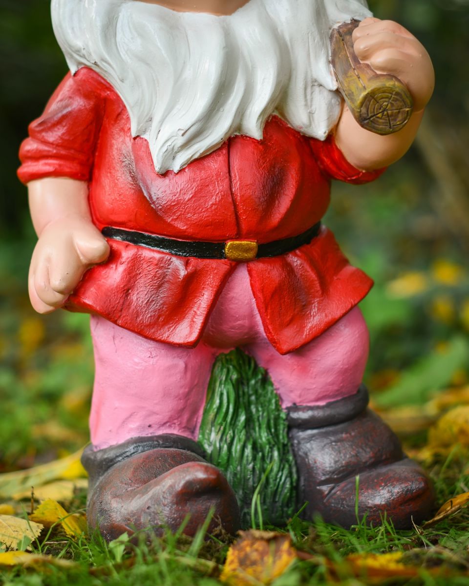 Close up of intricate clothes detail on colourful garden gnome sculpture
