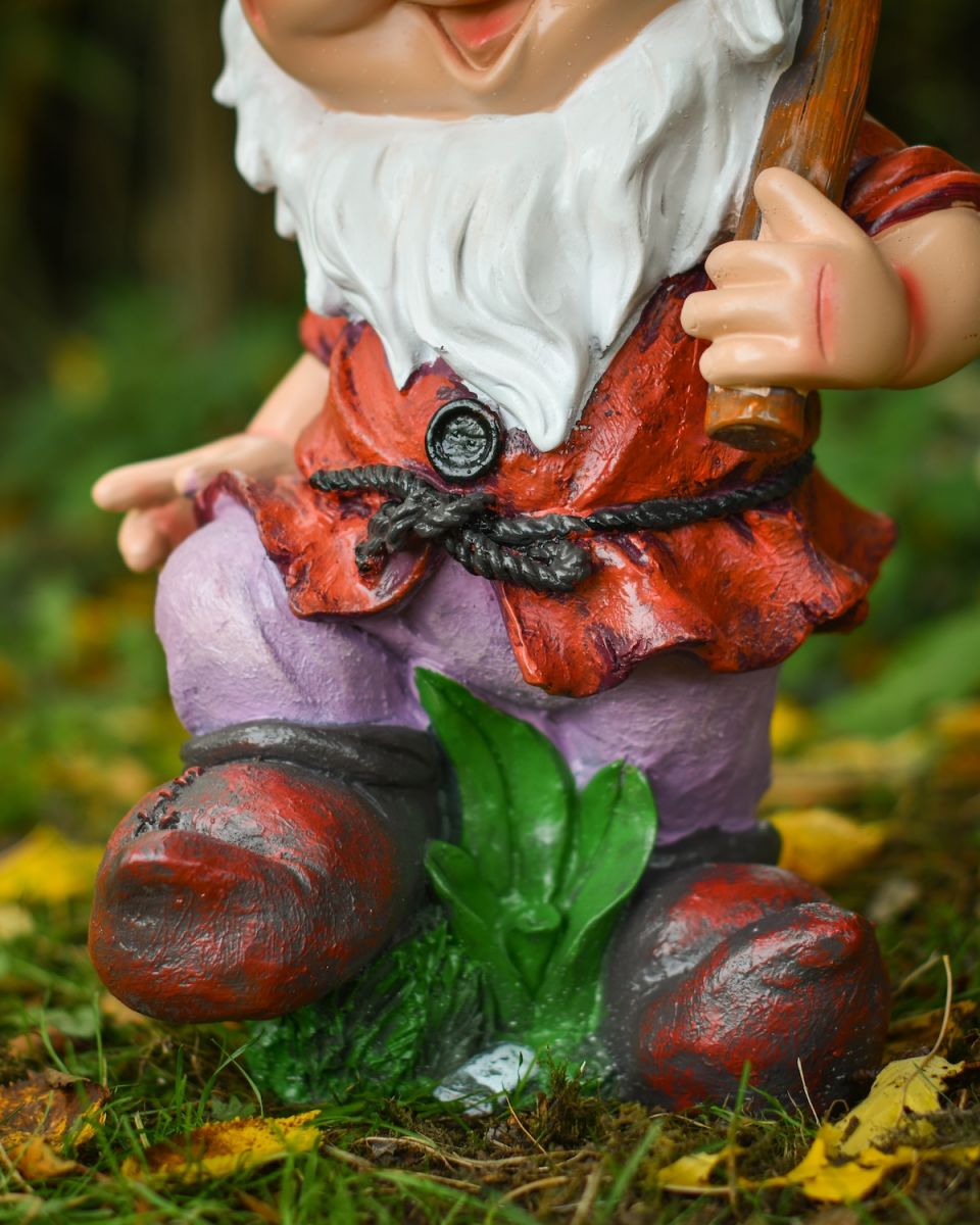 Close up of intricate clothes detail on colourful garden gnome sculpture
