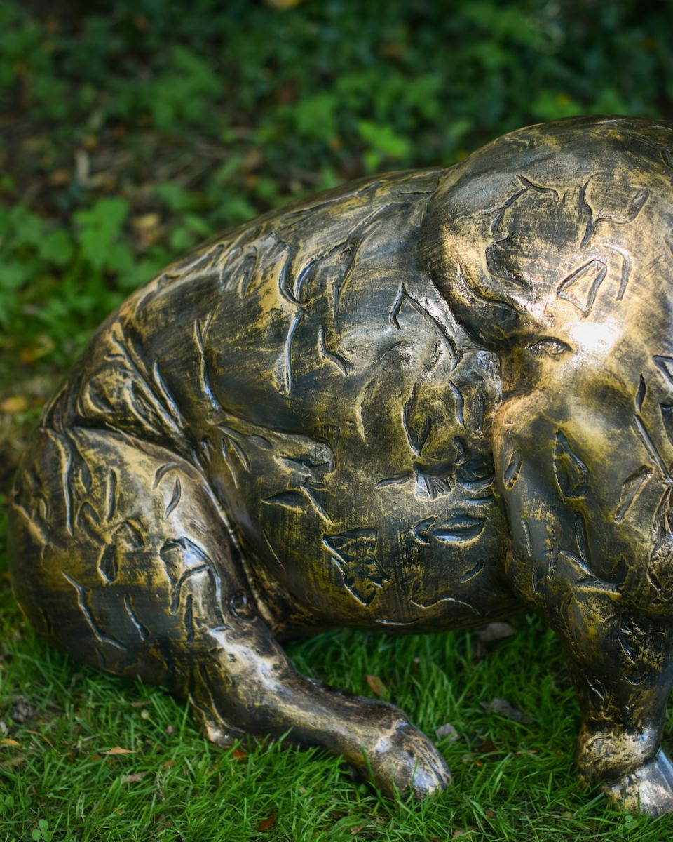 Close up of intricate body detail on brushed gold pig outdoor statue