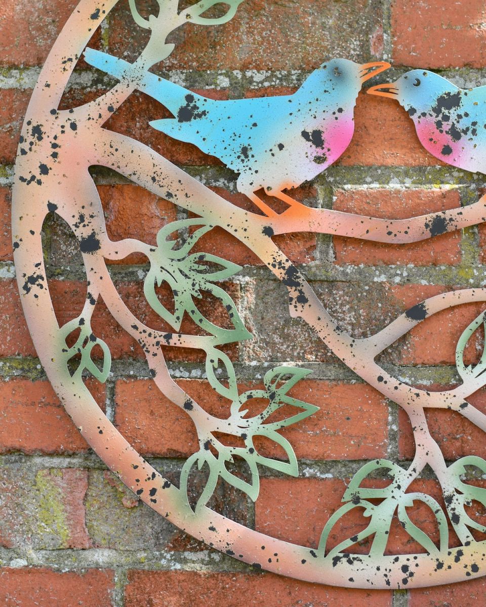 Close up of rustic branch detail on colourful garden wall art Close up of rustic branch detail on colourful garden wall art