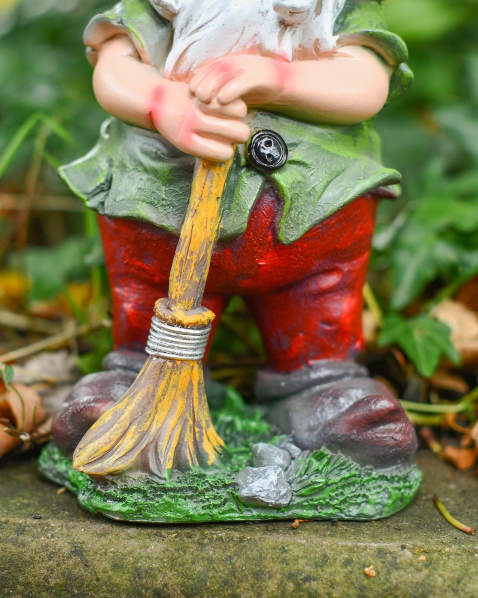 Close up of intricate broom detail on garden gnome ornament