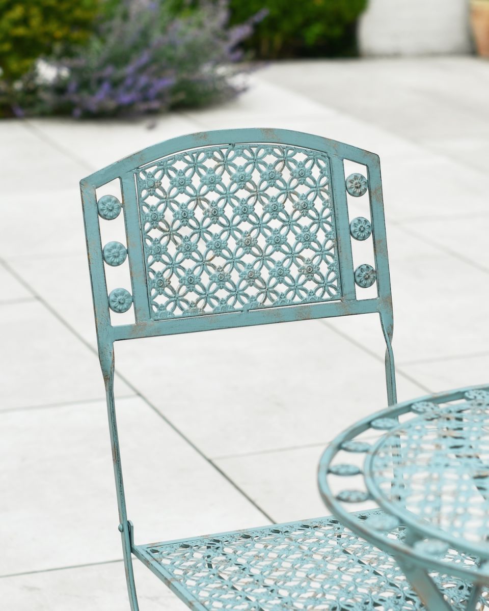 Close up of ornate chair backrest detail on patio furniture set