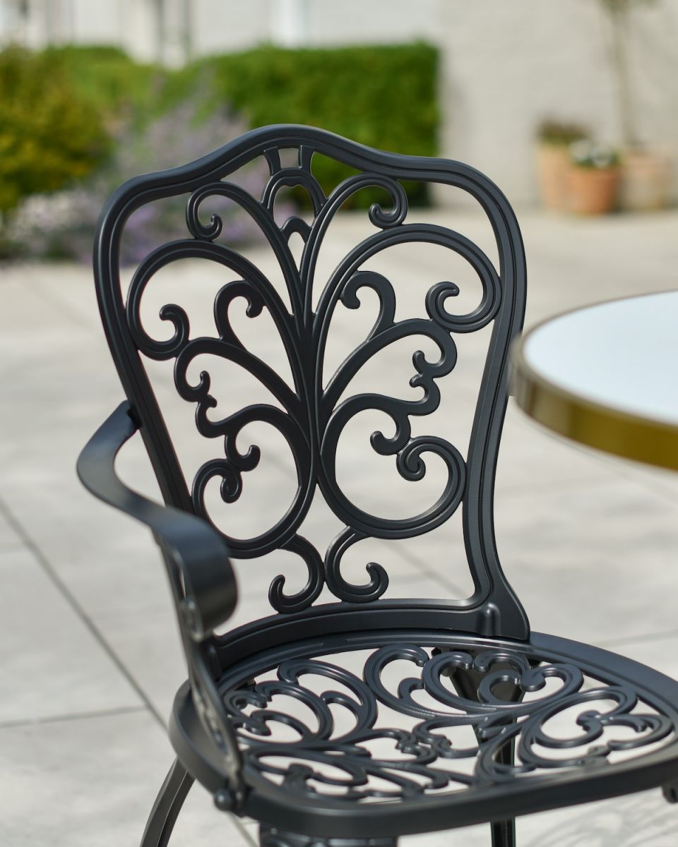 Close up of ornate backrest detail on outdoor two seater furniture set