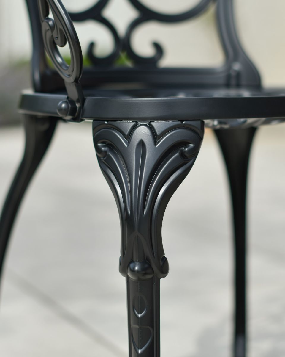 Close up of ornate chair leg detailing on two seater garden table and chairs set