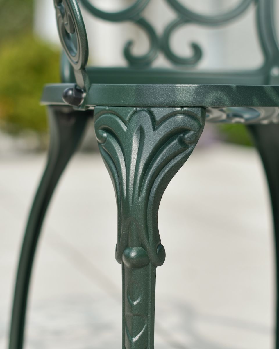 Close up of ornate chair leg detail in two seater garden bistro set