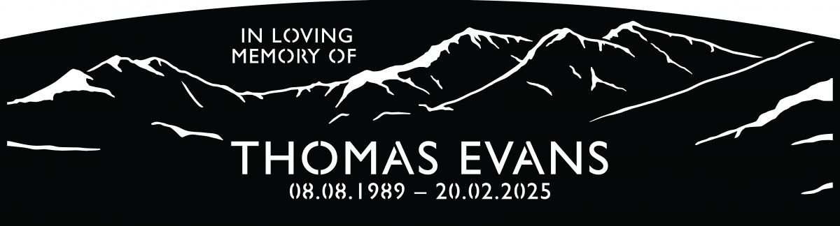 Close up of bench back mountain range detail on memorial garden park bench