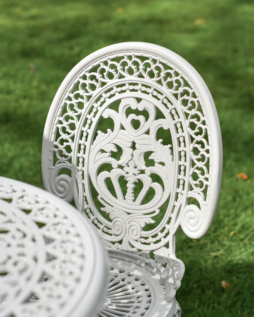 Decorative Circular Table and Cast Aluminium White Chair Close Up 