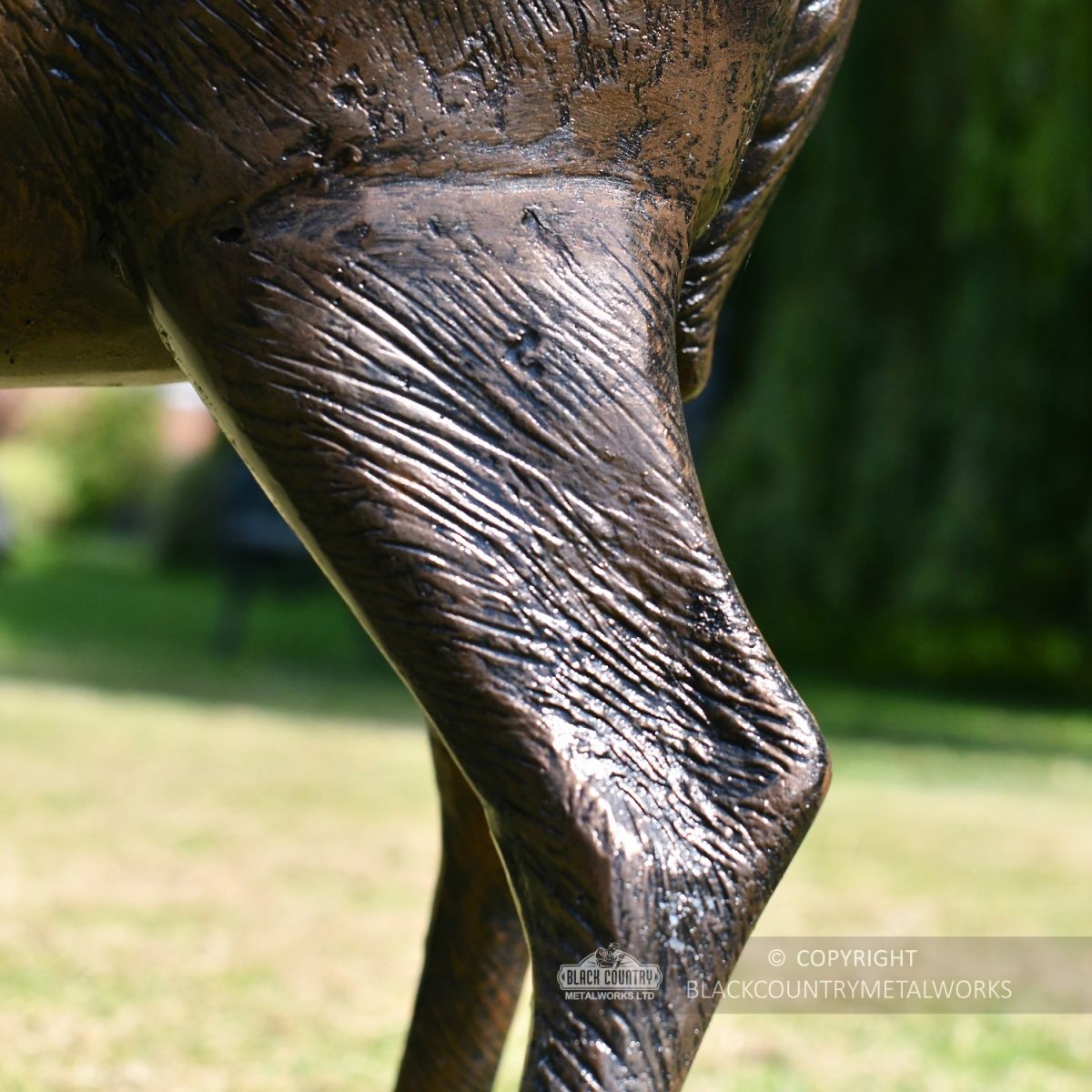 Close Up Of Doe Eating Garden Sculpture