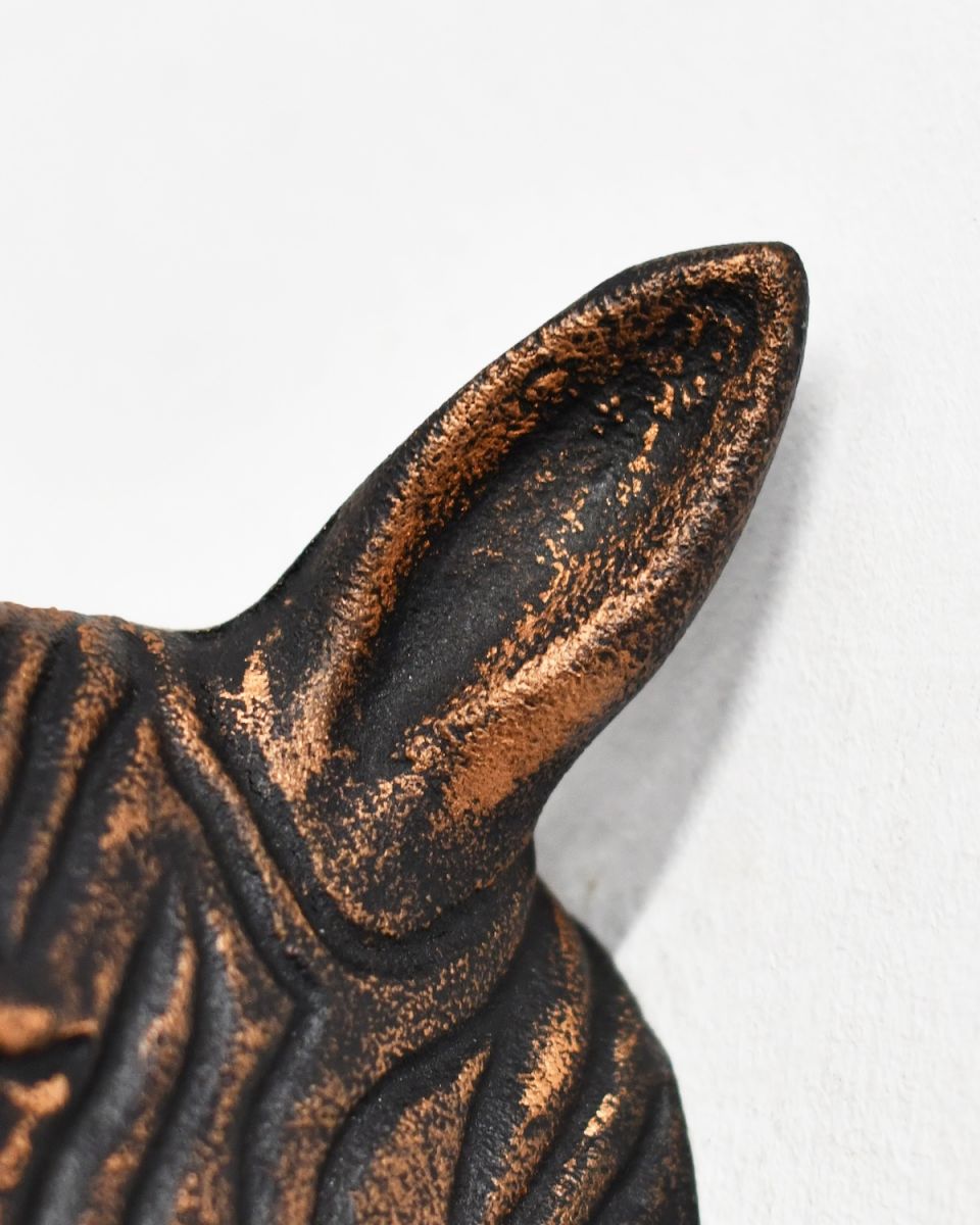 Close up of intricate ears detail on copper animal head wall bust