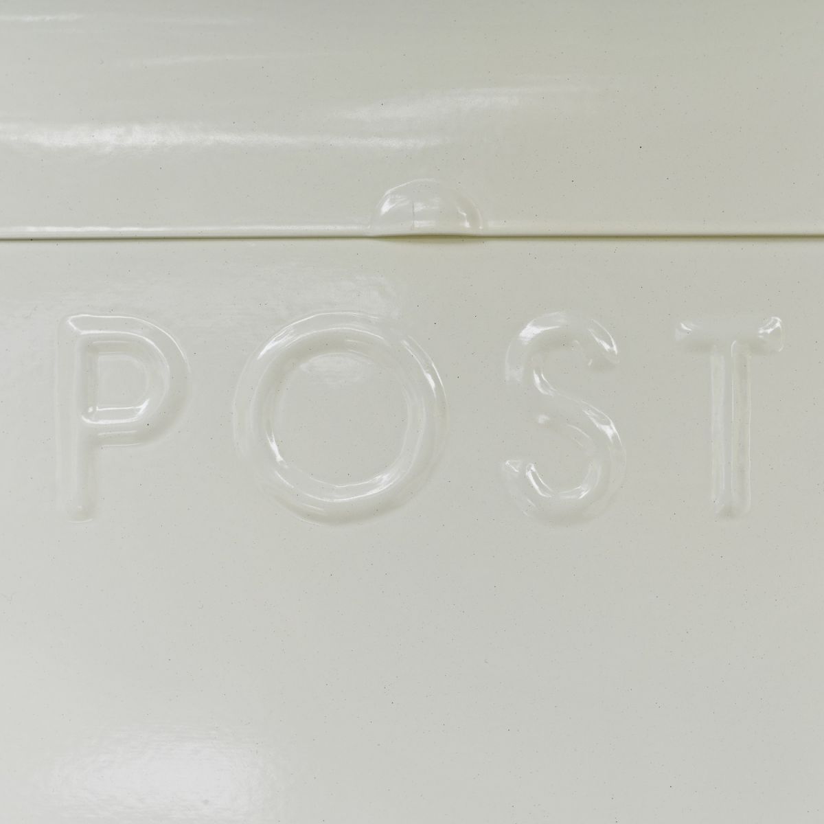 Close Up Of Embossed Lettering On Cream Post Box
