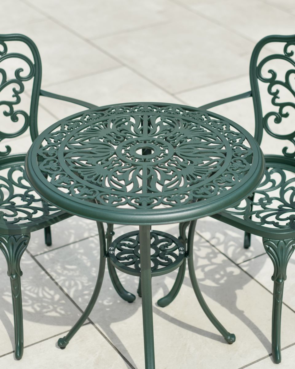 Close up of intricate table top detail and parasol hole in outdoor bistro set