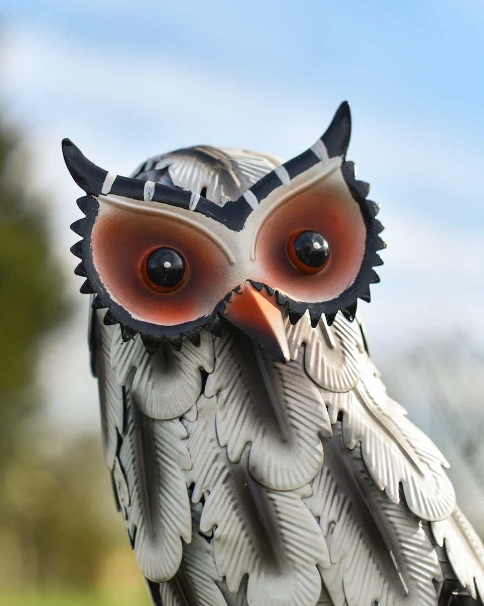 Close up of face detail on hand-painted patio sculpture