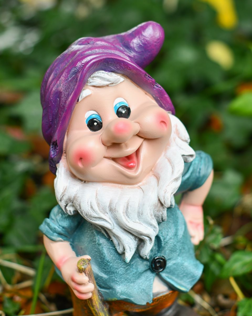 Close up of intricate face detail on colourful garden gnome sculpture