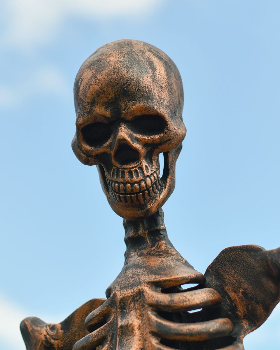 Close up of intricate copper face detail on skeleton outdoor sculpture