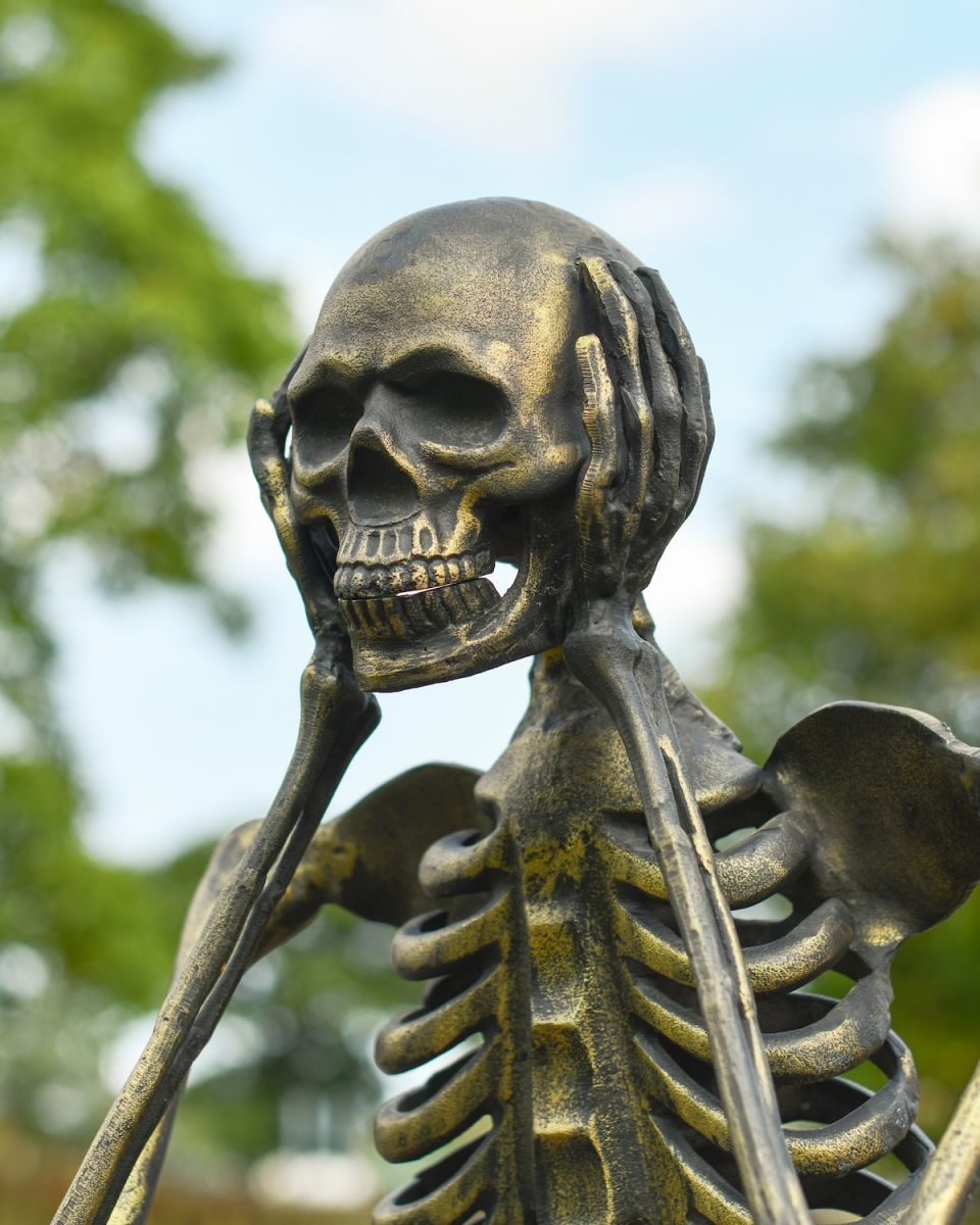 Close up of brushed gold finish on skeleton garden sculpture