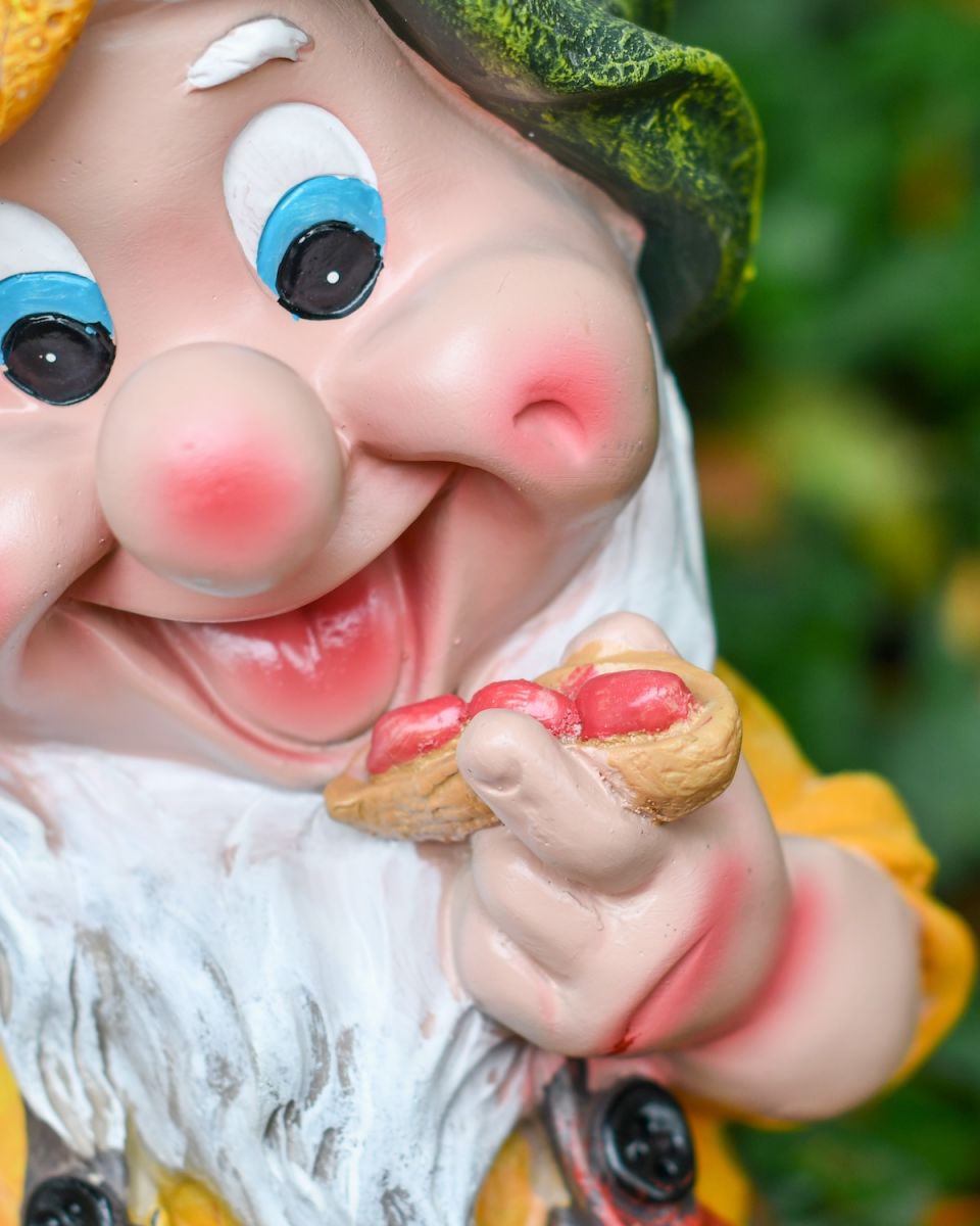 Close up of intricate face detail on colourful garden gnome ornament