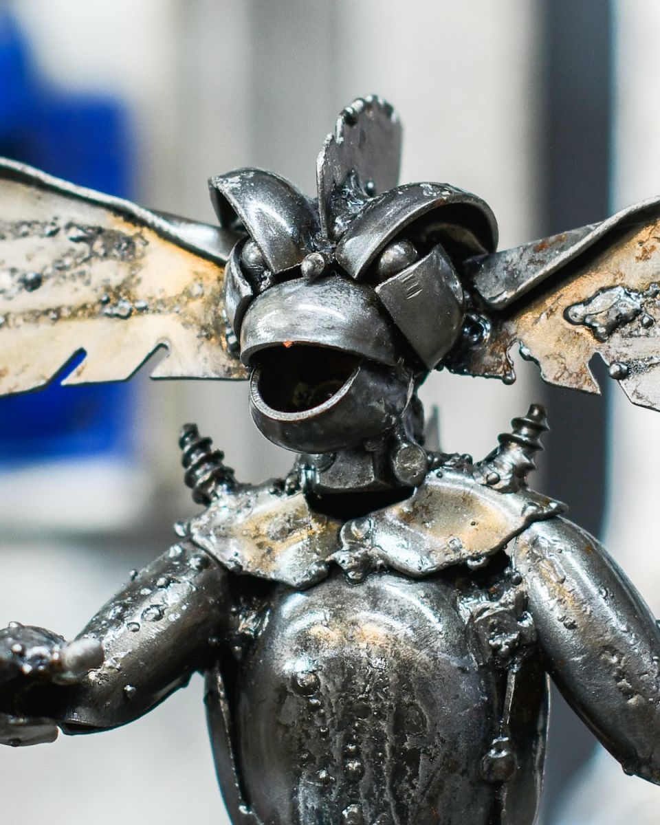 Close up of intricate face detail on recycled metal art sculpture