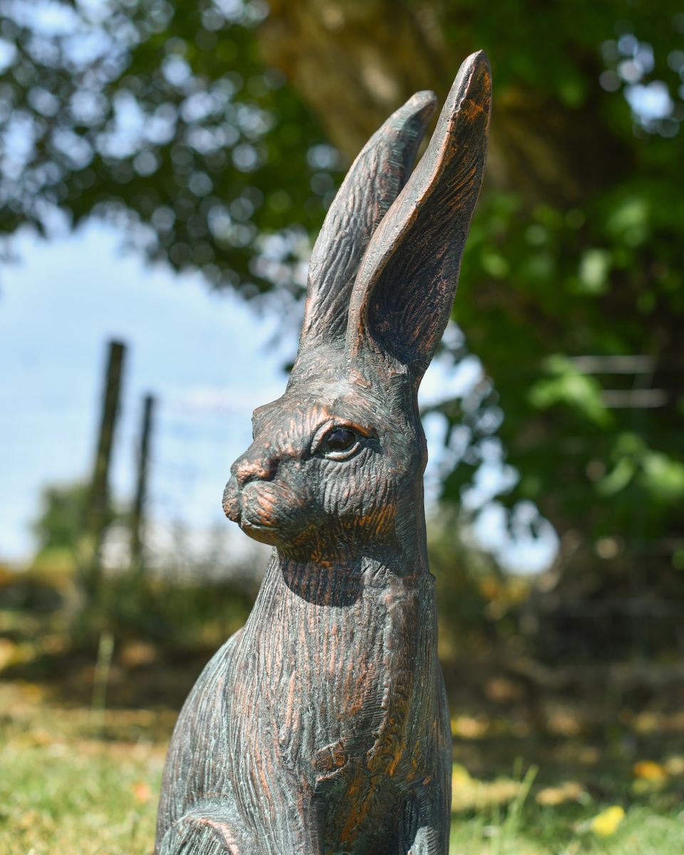 Close up of intricate face detail on rustic verdigris hare garden statue Close up of intricate face detail on rustic verdigris hare garden statue