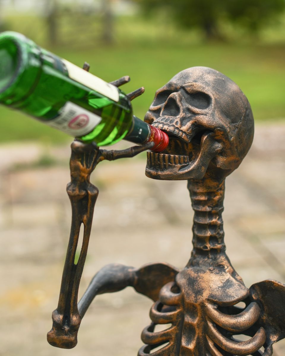 Close up of intricate face detail on drinking skeleton garden sculpture