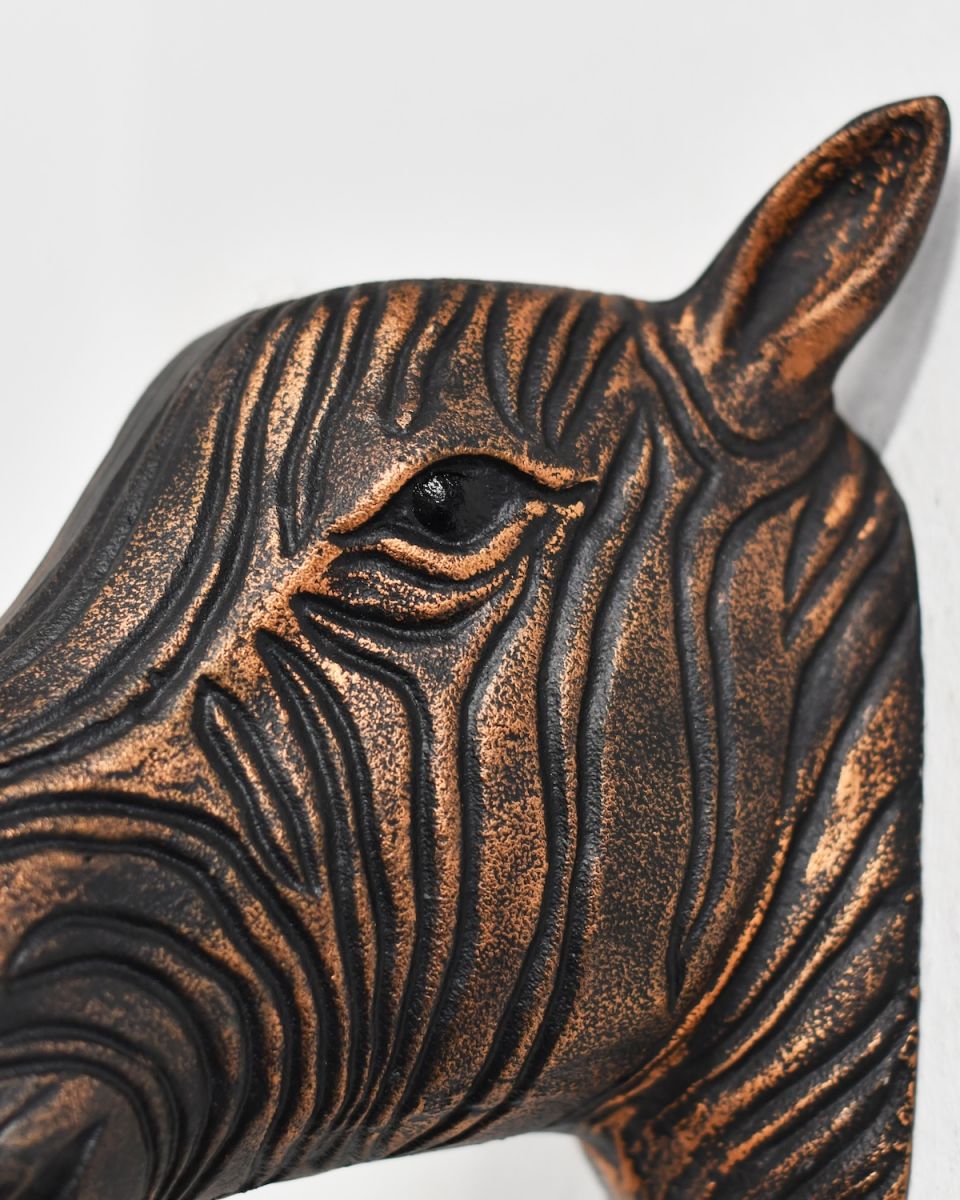 Close up of intricate face detail on copper zebra wall bust