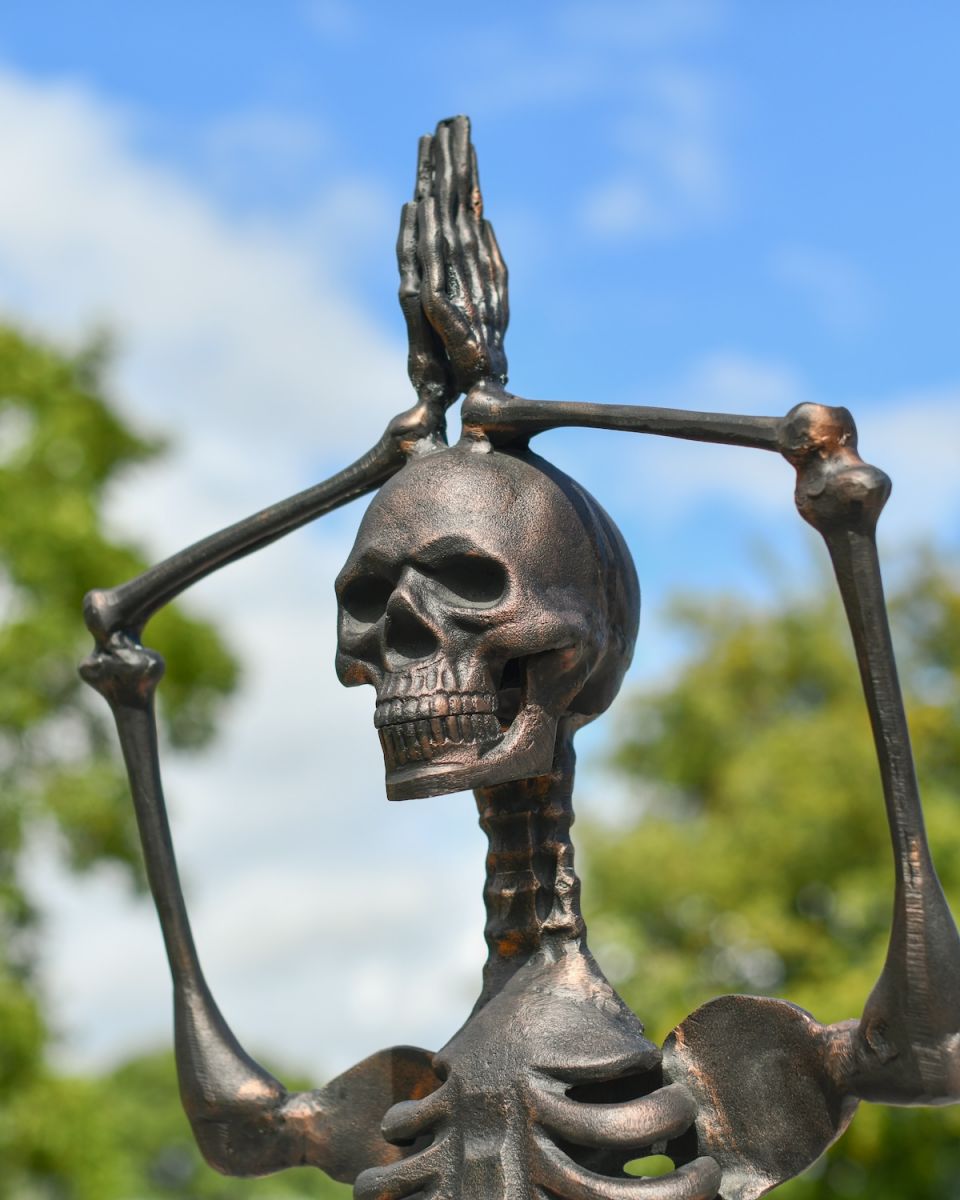 Close up of intricate face detail on skeleton garden sculpture