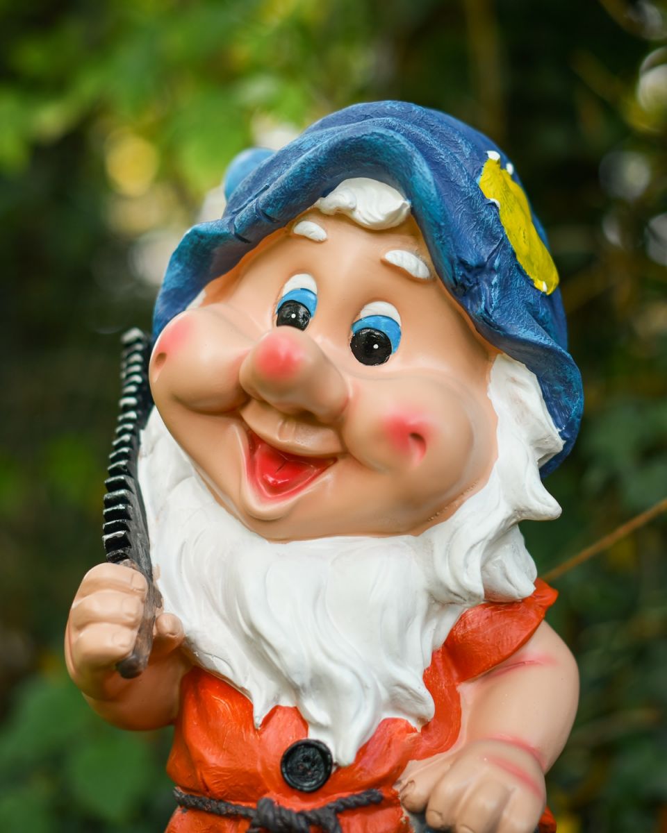 Close up of intricate face detail on colourful garden gnome ornament