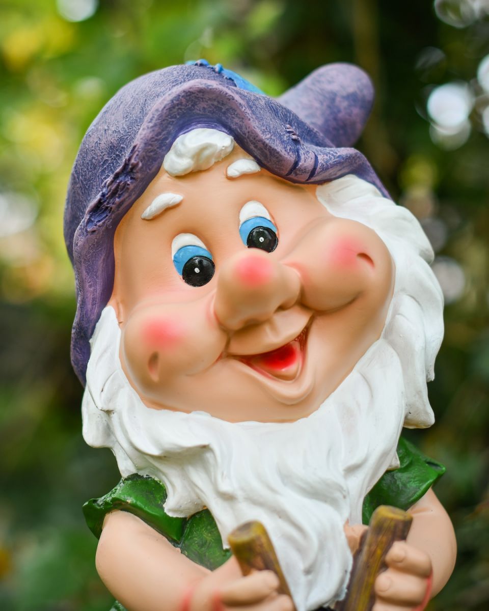 Close up of intricate face detail on colourful garden gnome ornament