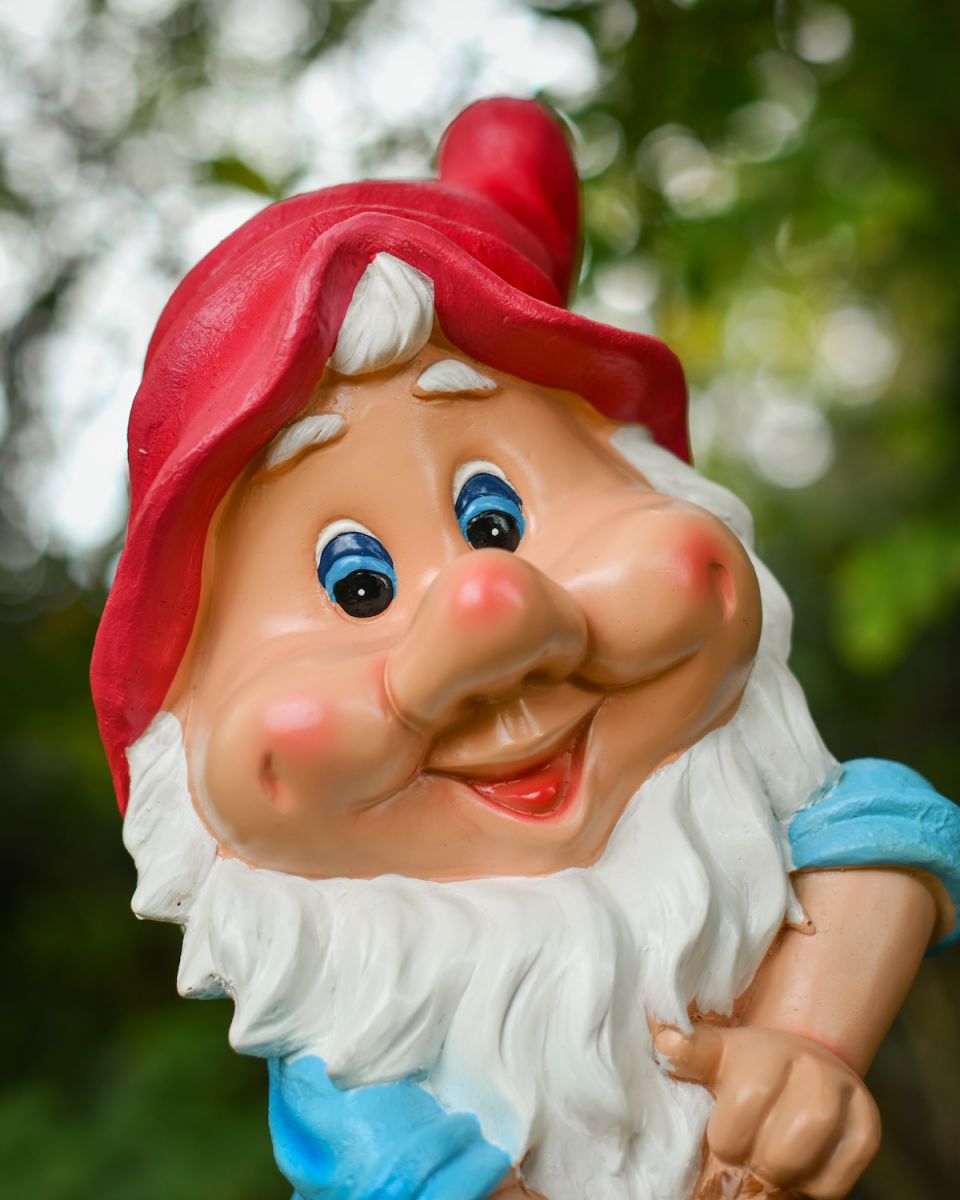 Close up of intricate detail on colourful garden gnome ornament Close up of intricate detail on colourful garden gnome ornament