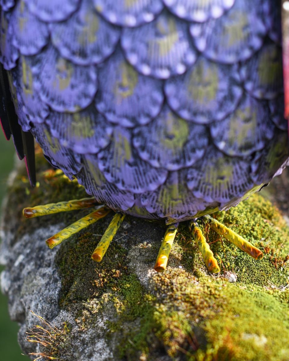 Close up of feet detail on colourful steel outdoor sculpture