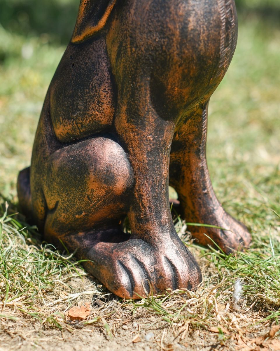 Close up of intricate feet detail on brushed bronze rabbit garden sculpture