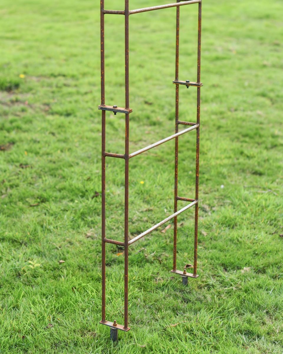 Close up of feet and fixings on rustic finish garden rose arch