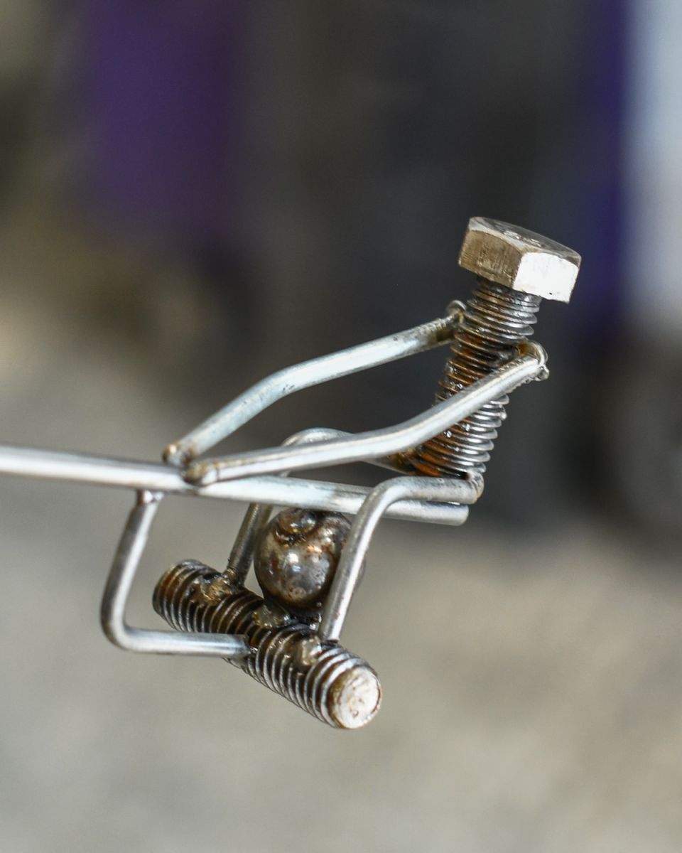 Close up of scrap metal figure detail seesaw home decor sculpture